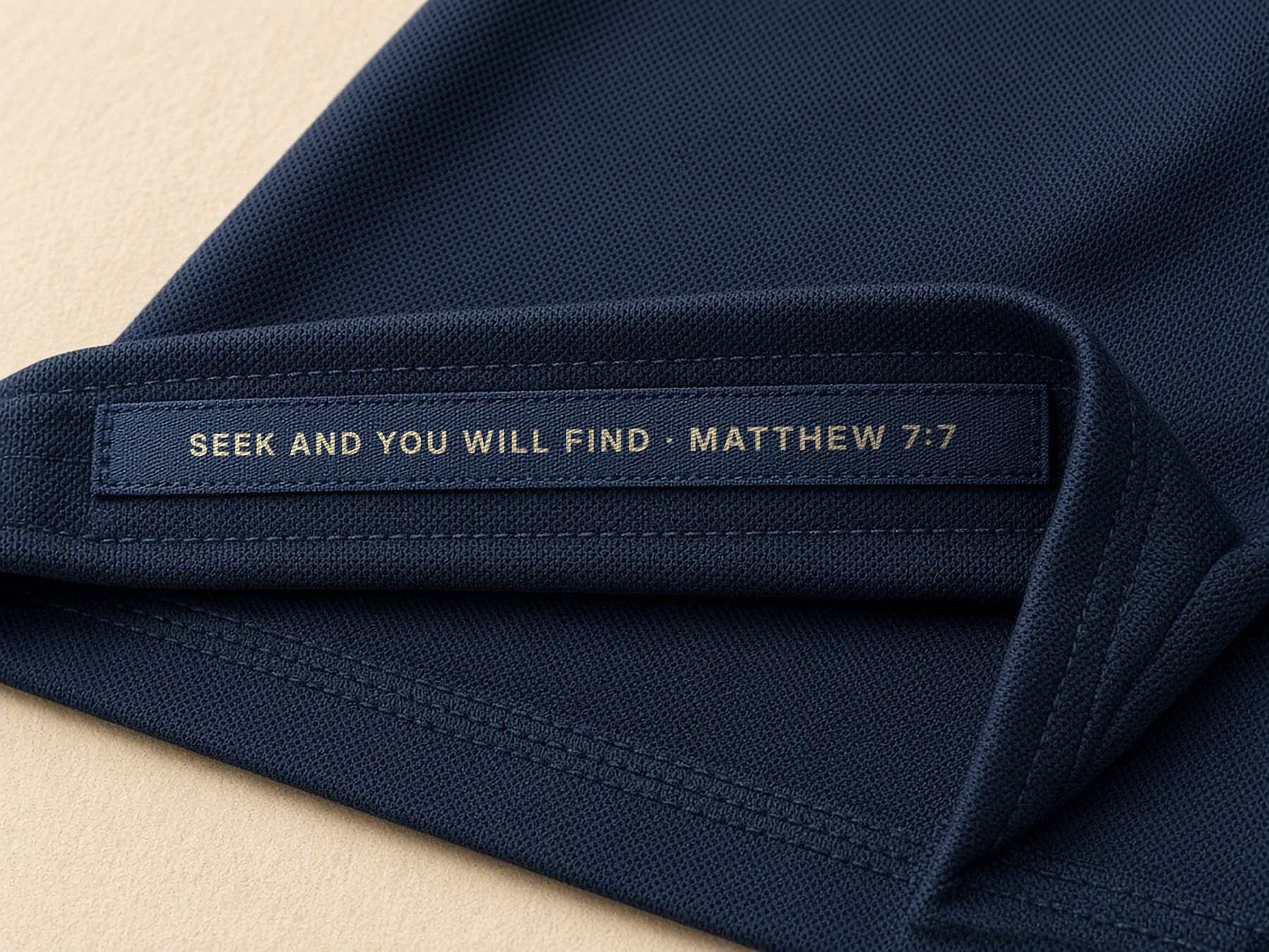 Woven verse tape inside the left front hem